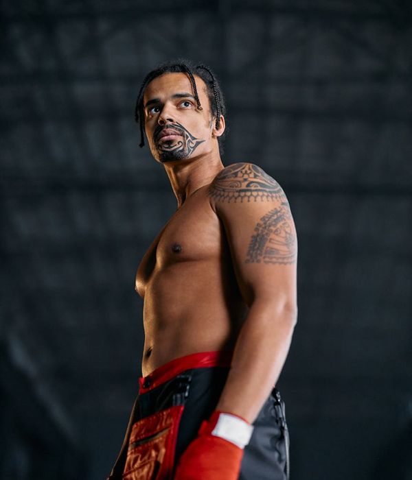 Male athlete in a powerful yoga warrior pose, demonstrating strength and focus.